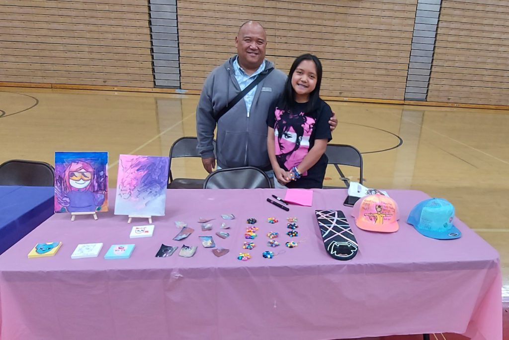 Artists like Addison Sierra (here with her proud father) learn how to interact with customers at the fair that concludes the program.  Monika Lee