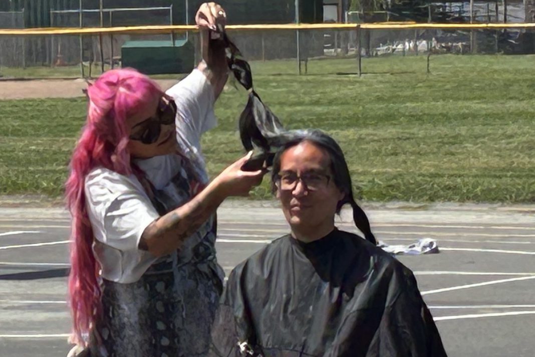 hair cutting ceremony School librarian puts books over looks